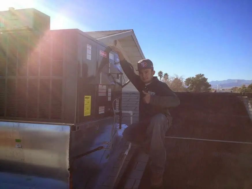 HVAC technician performing AC Tune-Up on a rooftop unit in Port Jervis